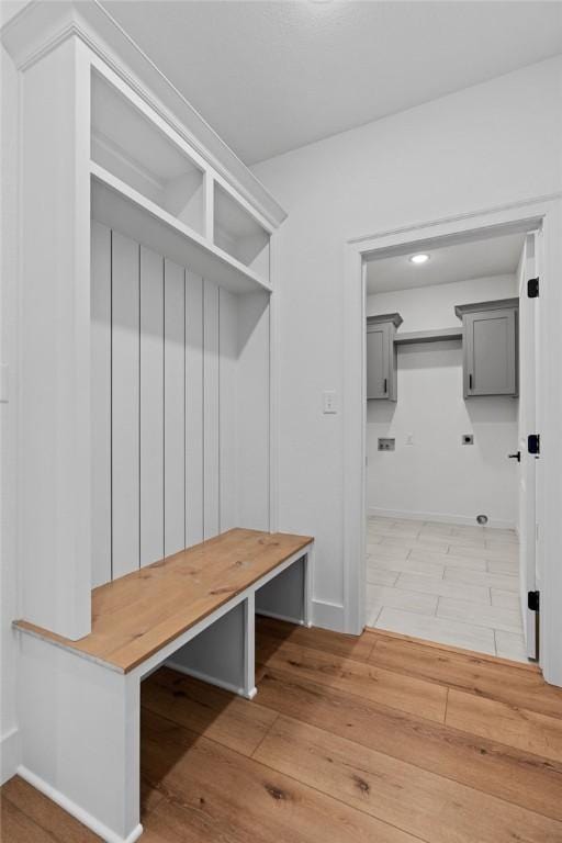 mudroom with baseboards and light wood-type flooring