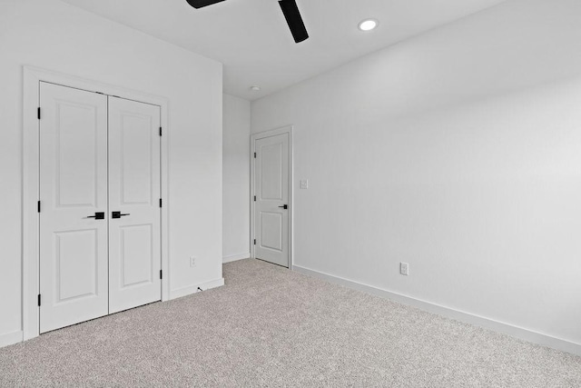 unfurnished bedroom featuring a closet, recessed lighting, ceiling fan, carpet flooring, and baseboards