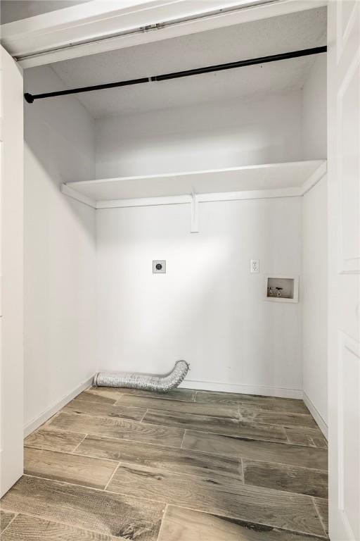 washroom featuring hookup for an electric dryer, laundry area, hookup for a washing machine, and wood tiled floor