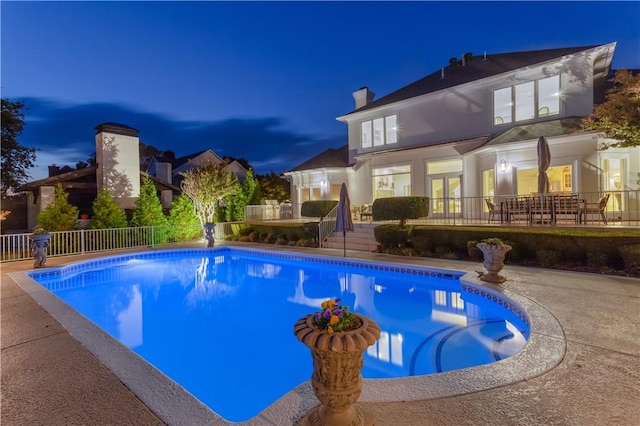 1800 Wheaton Trce, Fort Smith, AR 72908 - pool at night with french doors, a patio, a fenced in pool, and fence