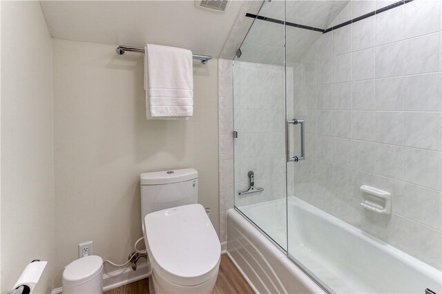 1800 Wheaton Trce, Fort Smith, AR 72908 - full bathroom featuring toilet, baseboards, bath / shower combo with glass door, visible vents, and wood finished floors