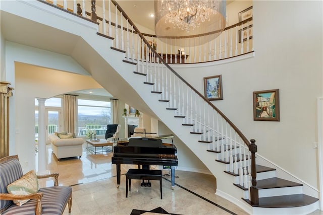 1800 Wheaton Trce, Fort Smith, AR 72908 - stairs with baseboards, marble finish floor, a high ceiling, an inviting chandelier, and ornate columns