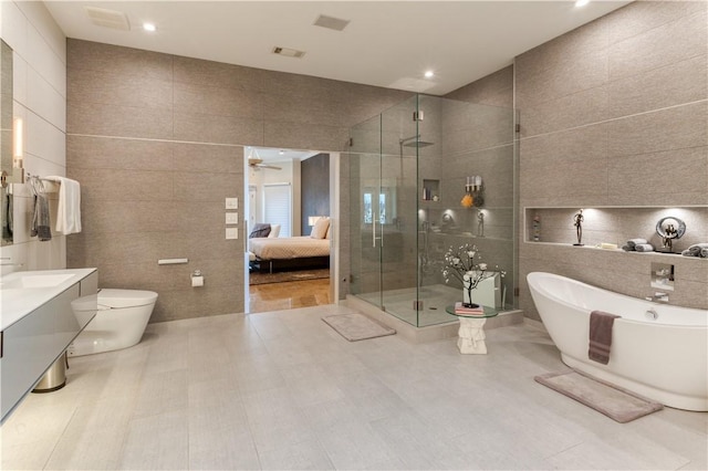 1800 Wheaton Trce, Fort Smith, AR 72908 - ensuite bathroom featuring a stall shower, tile walls, a freestanding tub, and toilet