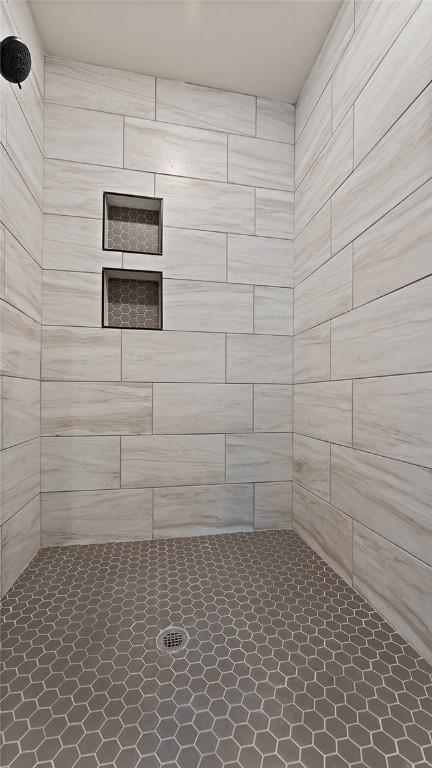 bathroom with tiled shower