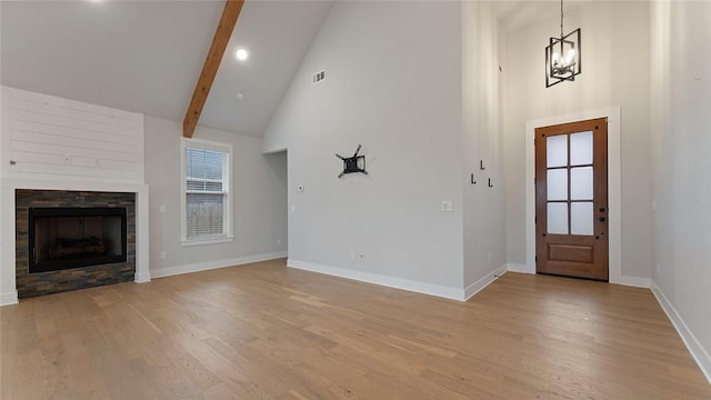 foyer entrance with high vaulted ceiling, light wood-style flooring, baseboards, a chandelier, and beamed ceiling