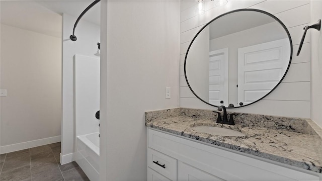 full bathroom with vanity, baseboards, and bathing tub / shower combination