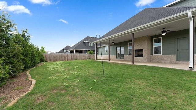 view of yard with ceiling fan and a patio area