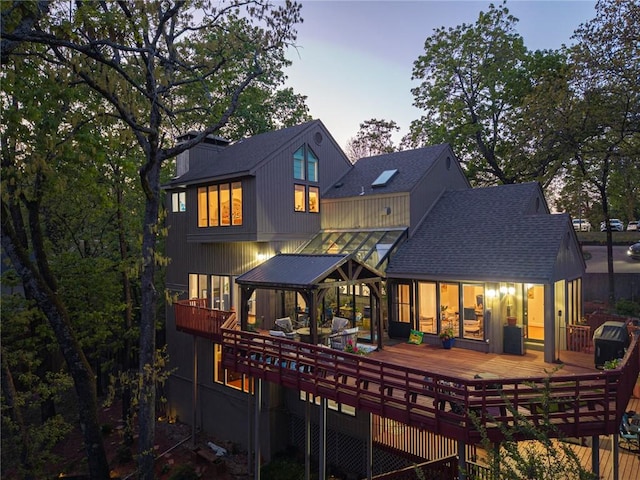 5008 Cliff Dr, Fort Smith, AR 72903 - back of property at dusk with a shingled roof and a deck