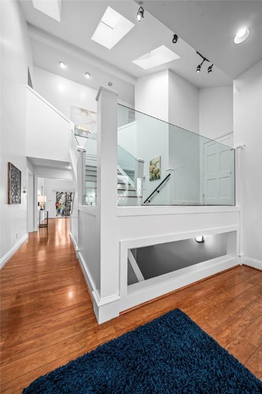 5008 Cliff Dr, Fort Smith, AR 72903 - hall with a skylight, wood finished floors, rail lighting, recessed lighting, and baseboards