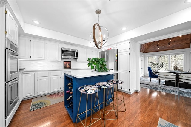 5008 Cliff Dr, Fort Smith, AR 72903 - kitchen with stainless steel appliances, a kitchen island, light countertops, white cabinetry, and recessed lighting