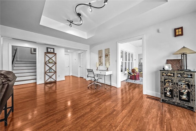 5008 Cliff Dr, Fort Smith, AR 72903 - living room featuring a tray ceiling, stairs, wood finished floors, and baseboards