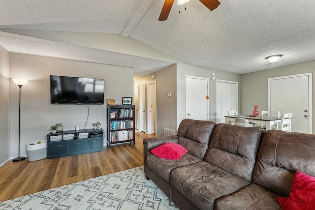 1165 Massey St, Decatur, AR 72722 - living room with wood finished floors, a ceiling fan, a textured ceiling, visible vents, and baseboards