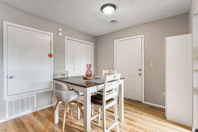 1165 Massey St, Decatur, AR 72722 - dining area featuring light wood-type flooring, baseboards, and visible vents
