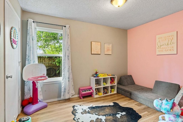 1165 Massey St, Decatur, AR 72722 - recreation room with a textured ceiling and wood finished floors