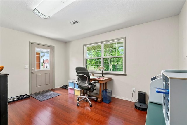 office area with visible vents, wood finished floors, and baseboards