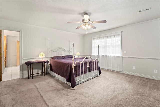 bedroom with ornamental molding, visible vents, and carpet