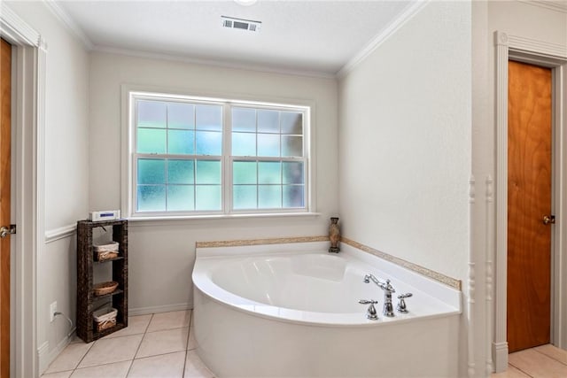 full bath featuring tile patterned flooring, a wealth of natural light, a garden tub, and visible vents