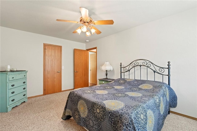 carpeted bedroom with baseboards and ceiling fan