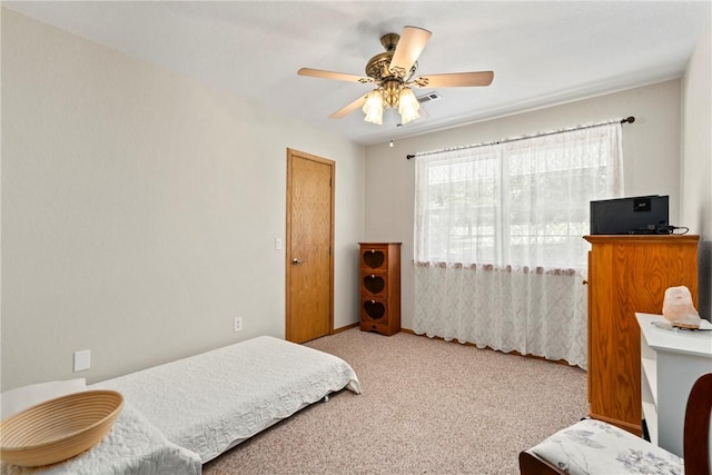 carpeted bedroom with baseboards and a ceiling fan