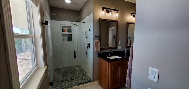 bathroom with vanity, tile patterned flooring, and a stall shower