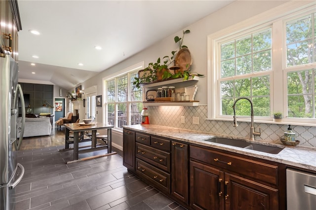 7 Croft Ledge Dr, Bentonville, AR 72712 - kitchen with a sink, appliances with stainless steel finishes, tasteful backsplash, light stone countertops, and recessed lighting