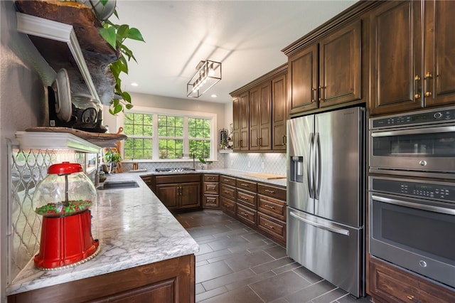 7 Croft Ledge Dr, Bentonville, AR 72712 - kitchen featuring stainless steel appliances, tasteful backsplash, a sink, recessed lighting, and dark tile patterned flooring