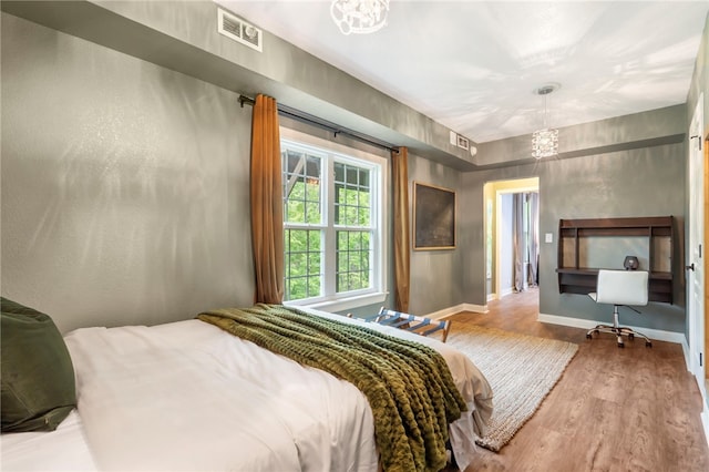 7 Croft Ledge Dr, Bentonville, AR 72712 - bedroom featuring wood finished floors, a chandelier, and baseboards