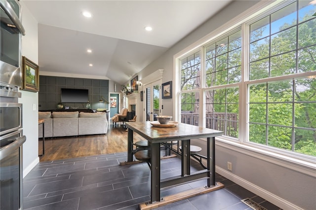 7 Croft Ledge Dr, Bentonville, AR 72712 - dining room with plenty of natural light, baseboards, recessed lighting, lofted ceiling, and dark tile patterned floors