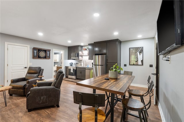 7 Croft Ledge Dr, Bentonville, AR 72712 - dining space featuring baseboards, recessed lighting, and wood finished floors