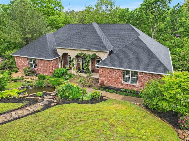7 Croft Ledge Dr, Bentonville, AR 72712 - view of front of house featuring roof with shingles, brick siding, and a front lawn