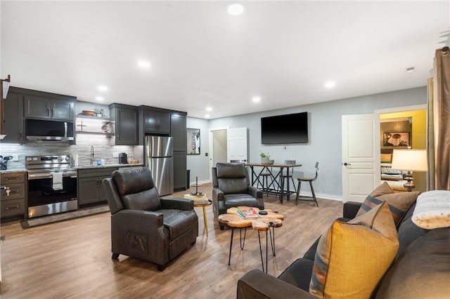 7 Croft Ledge Dr, Bentonville, AR 72712 - living room featuring light wood-type flooring, baseboards, and recessed lighting