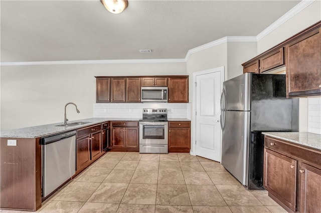 kitchen featuring a sink, crown molding, tasteful backsplash, and appliances with stainless steel finishes