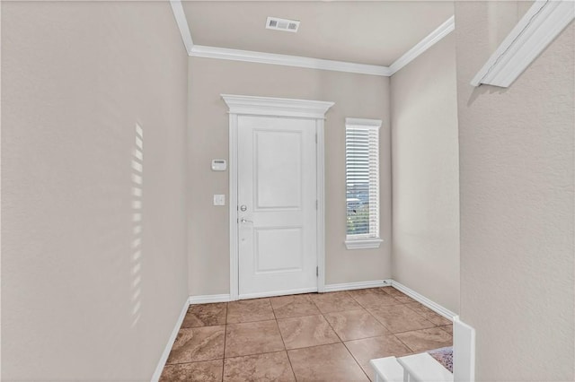 foyer entrance featuring baseboards, crown molding, and visible vents