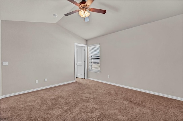 empty room with carpet floors, lofted ceiling, baseboards, and a ceiling fan