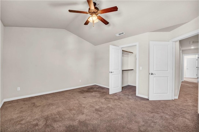 unfurnished bedroom featuring lofted ceiling, carpet flooring, baseboards, and visible vents