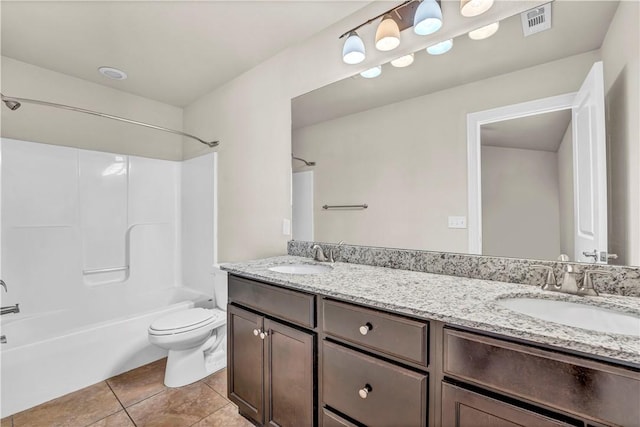 full bathroom with toilet, tile patterned flooring, double vanity, and a sink