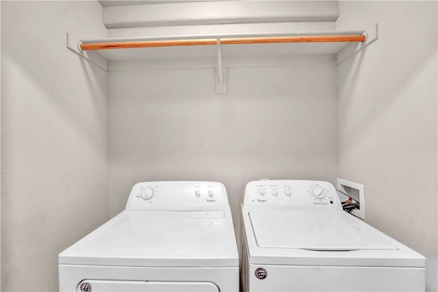 laundry room featuring washing machine and clothes dryer and laundry area
