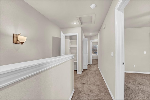 corridor with light colored carpet, attic access, baseboards, and recessed lighting