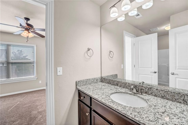 bathroom with vanity, baseboards, ceiling fan, and visible vents