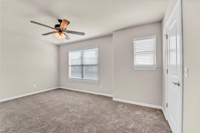 carpeted empty room with baseboards and a ceiling fan