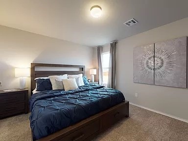 carpeted bedroom featuring visible vents and baseboards