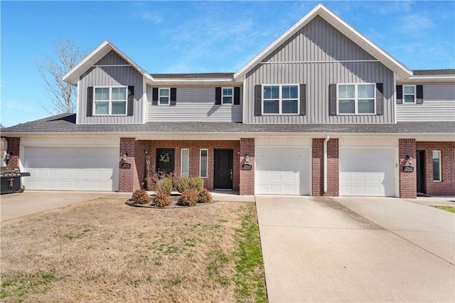 2769 W Kilimanjaro Way, Rogers, AR 72758 - view of front of house featuring driveway, brick siding, and board and batten siding