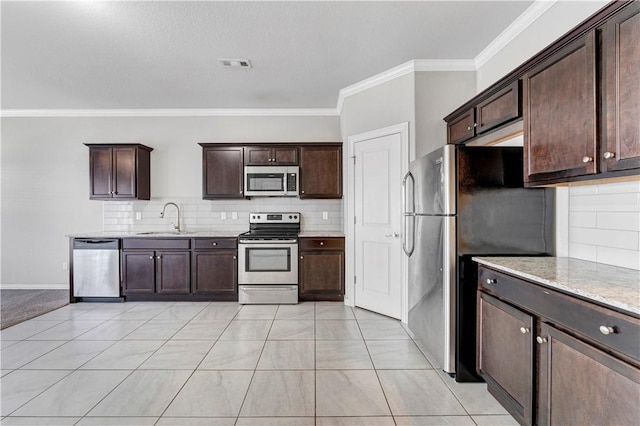 2769 W Kilimanjaro Way, Rogers, AR 72758 - kitchen featuring crown molding, appliances with stainless steel finishes, dark brown cabinets, and a sink