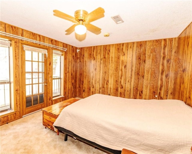 315 N Letitia Ave, Fayetteville, AR 72701 - bedroom featuring wooden walls, light carpet, and a ceiling fan