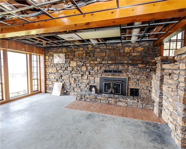 315 N Letitia Ave, Fayetteville, AR 72701 - unfurnished living room featuring unfinished concrete floors and a stone fireplace