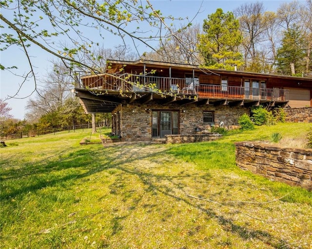 315 N Letitia Ave, Fayetteville, AR 72701 - back of house featuring a yard, a wooden deck, and stone siding
