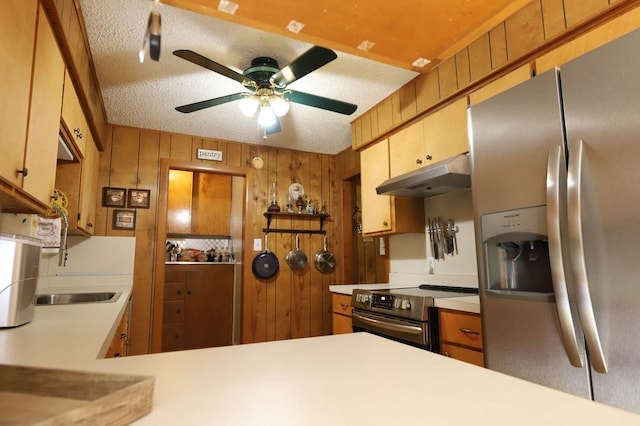 602 Centennial Ave, West Fork, AR 72774 - kitchen with under cabinet range hood, ceiling fan, wooden walls, light countertops, and appliances with stainless steel finishes