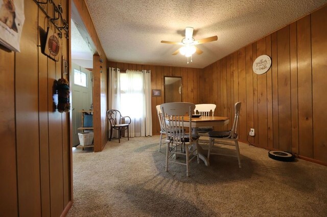 602 Centennial Ave, West Fork, AR 72774 - dining space featuring light colored carpet, a textured ceiling, wood walls, and ceiling fan