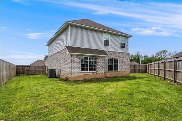 rear view of house with a shingled roof, brick siding, a lawn, and a fenced backyard