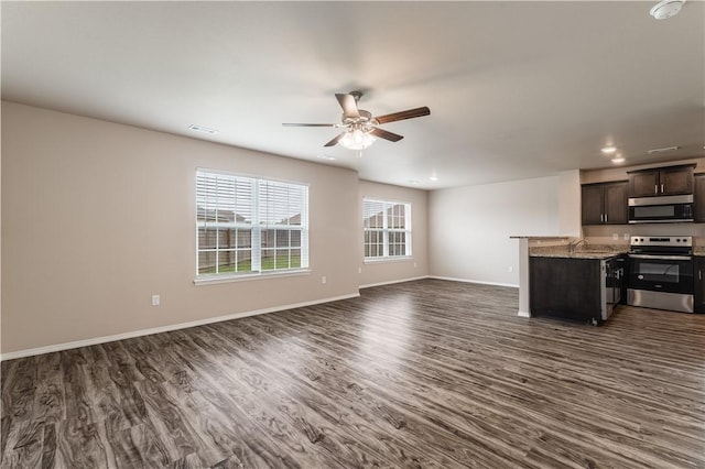 unfurnished living room featuring recessed lighting, baseboards, ceiling fan, and dark wood-style floors